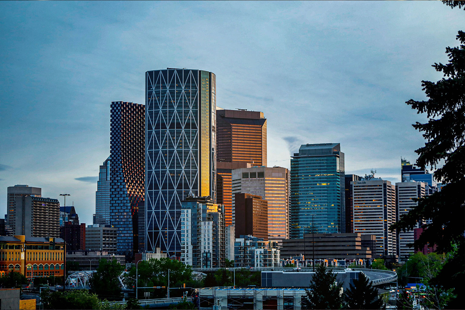 Downtown Calgary skyline with the iconic Calgary Tower illuminated at blue hour.